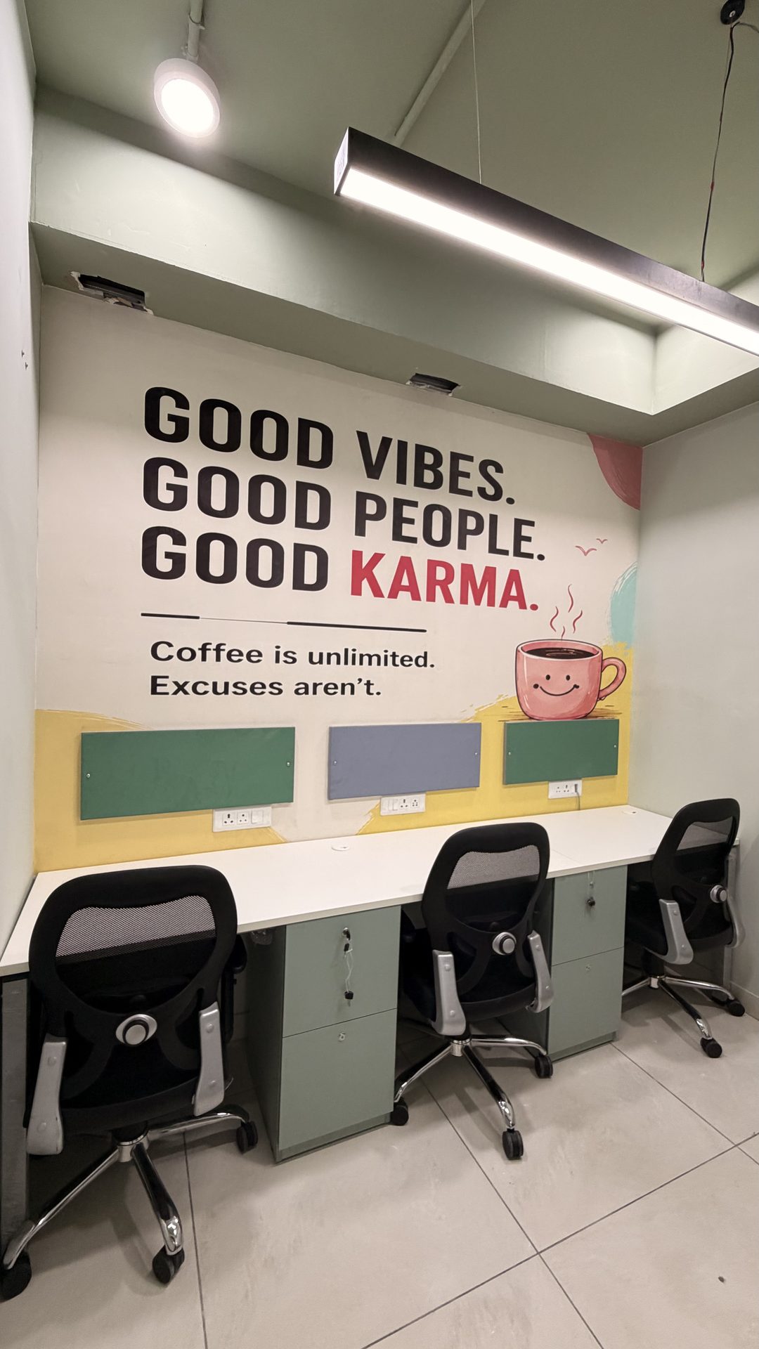 Karmhut day pass desk with Good Vibes Good Karma mural