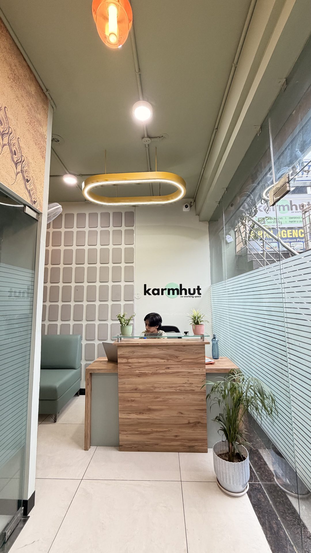 Karmhut reception desk with logo wall